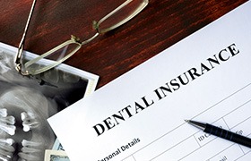 A dental insurance form on a wooden table